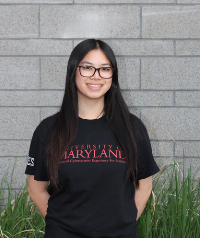 Photo of Emily Ho in front of a gray brick wall