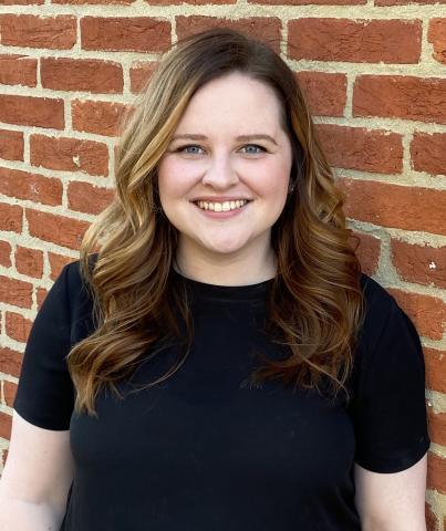 Sarah Herberger against a brick wall